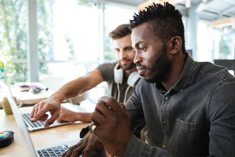 Professionals working together on laptops in a bright modern office